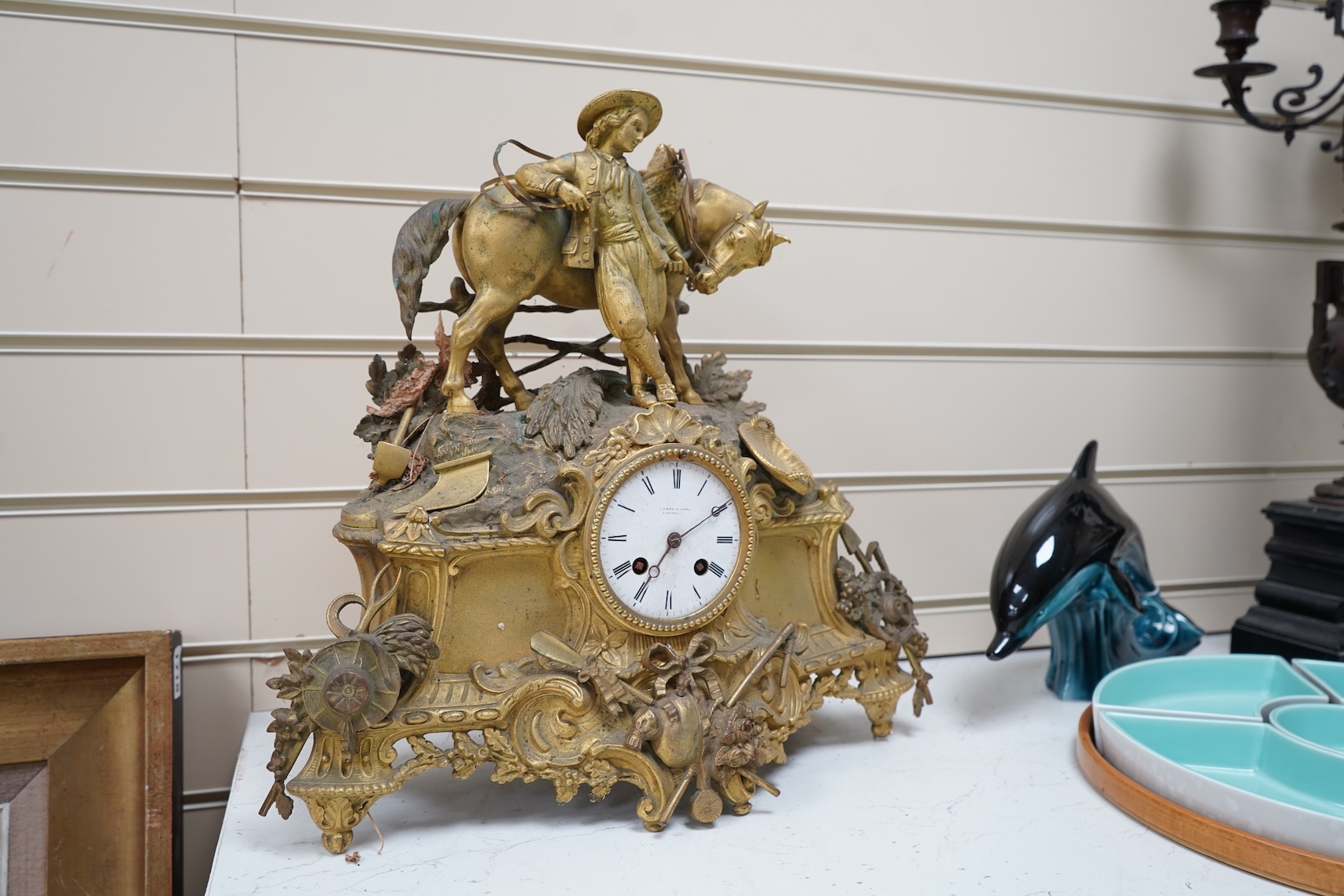 A 19th century French gilt spelter clock surmounted with a horse and rider, 39cm high